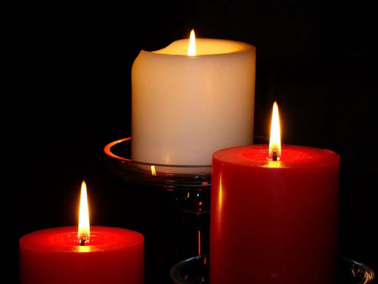 Three candles with a flame